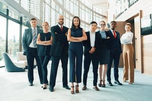 Group of business professional standing in office and facing the camera