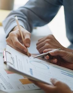 Business coworkers discussing a financial planning graph during a meeting in office room